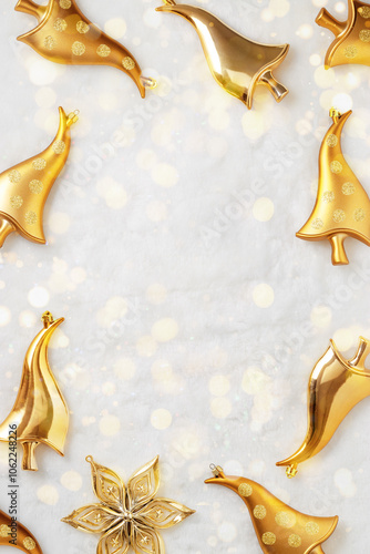 New Year Eve holiday frame, Shiny Christmas ornaments golden color mushrooms, sparkling star on white fur background with bokeh lights. Glittering festive decor Christmas trees, copyspace background photo