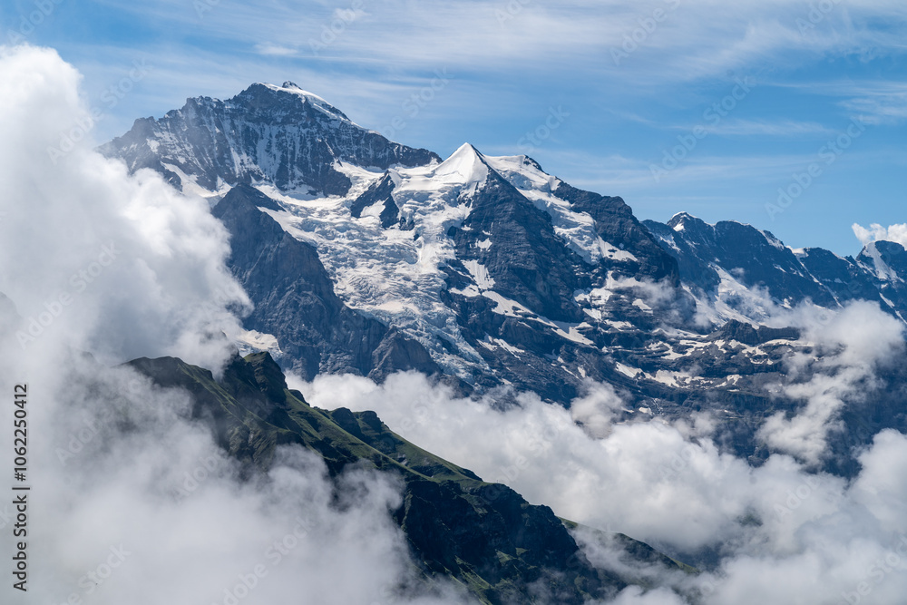 Swiss alps as seen from Mannlichen Switzerland, summertime, with clouds Swiss alps as seen from Mannlichen Switzerland, summertime, with clouds