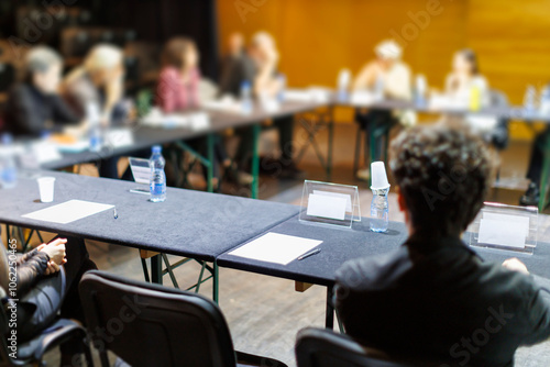 A group meets around a table for a collaborative discussion during an event in a community center setting