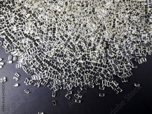 Transparent polycarbonate plastic granules on a black background, one of the main materials in the plastics industry. photo