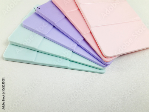 Various pastel colors of color chips on a white background, color references produced by masterbatch in the plastics industry.