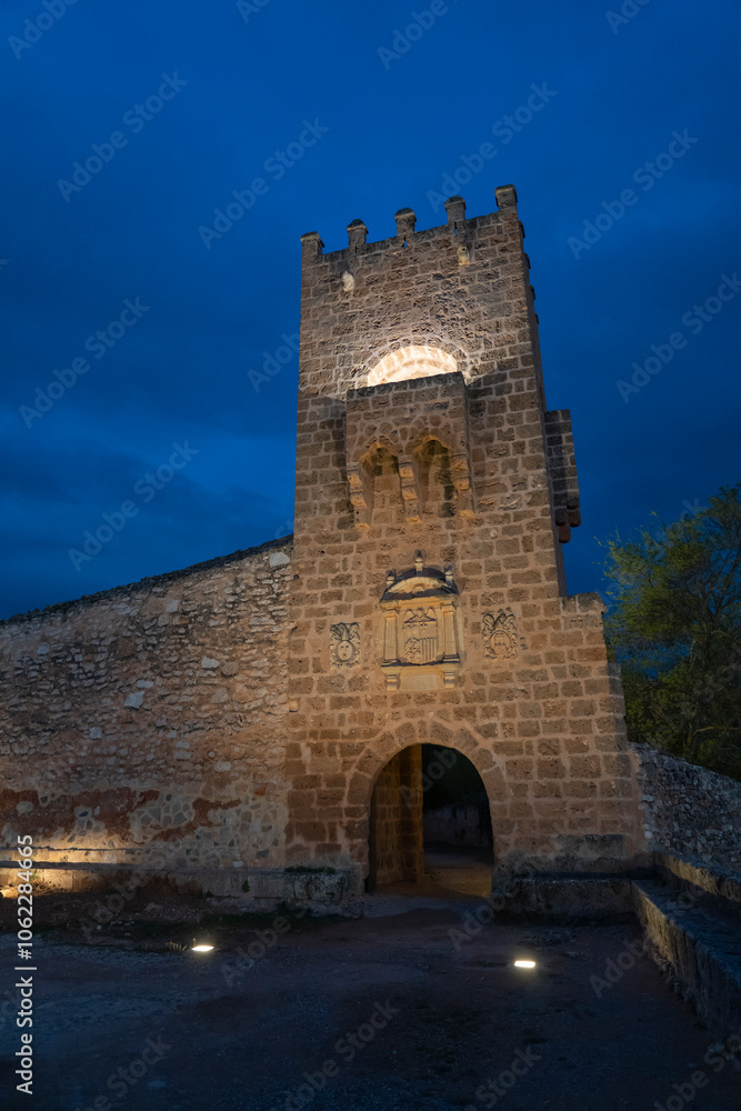 Evening view of the historic Monasterio de Piedra ruins, softly lit under a deep blue twilight sky. Perfect for themes of history, architecture, and travel.