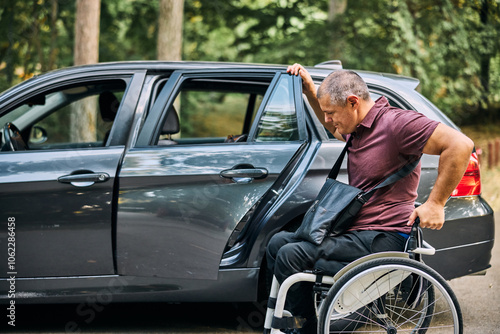 Man in Wheelchair Preparing to Transfer Into Car