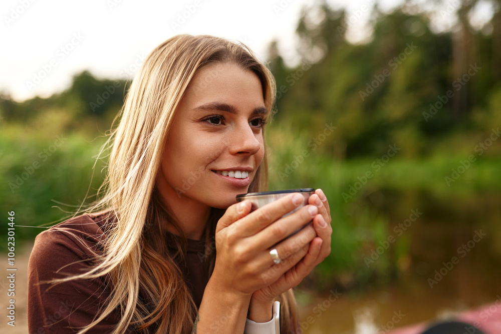 A Young Woman Happily Enjoys a Warm Drink While Surrounded by Beautiful Nature Scenery A Young Woman Happily Enjoys a Warm Drink While Surrounded by Beautiful Nature Scenery