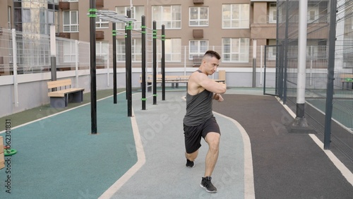 Sportsman engaging in arm stretches on a rooftop before outdoor workout