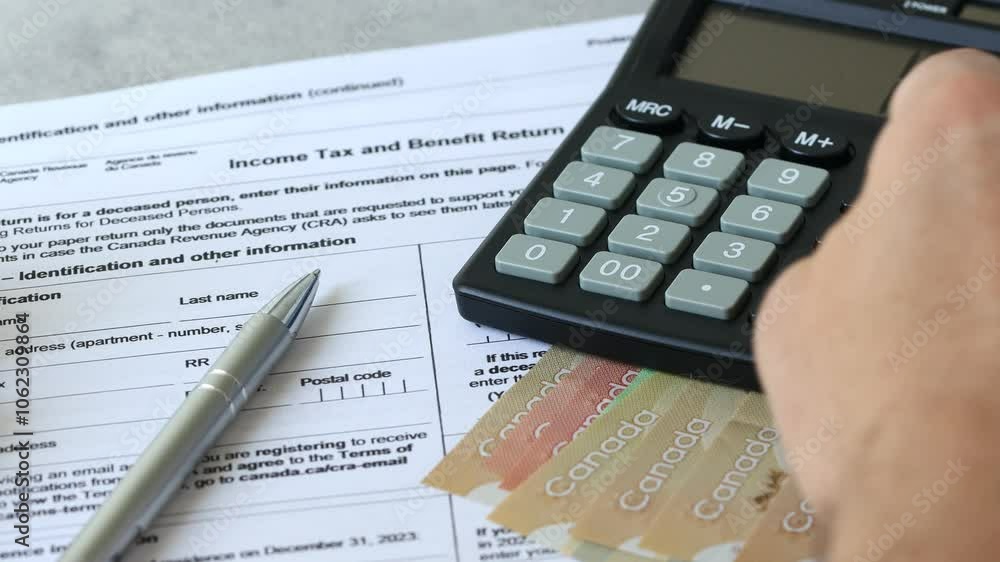 Income tax return in Canada. Financial concept. Tax form, Canadian dollars and tax calculation on calculator. close up Income tax return in Canada. Financial concept. Tax form, Canadian dollars and tax calculation on calculator. close up