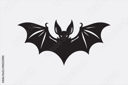 A black silhouette of a flying bat with outstretched wings.