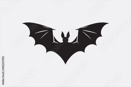 A black silhouette of a flying bat with outstretched wings.