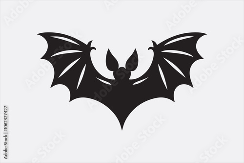 A black silhouette of a flying bat with outstretched wings.