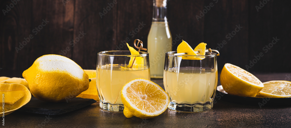 Traditional homemade limoncello in glasses on the table web banner