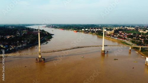 Aerial view of the Gentala Arashi Bridge located in Jambi which is known as the first arched bridge in Indonesia photo