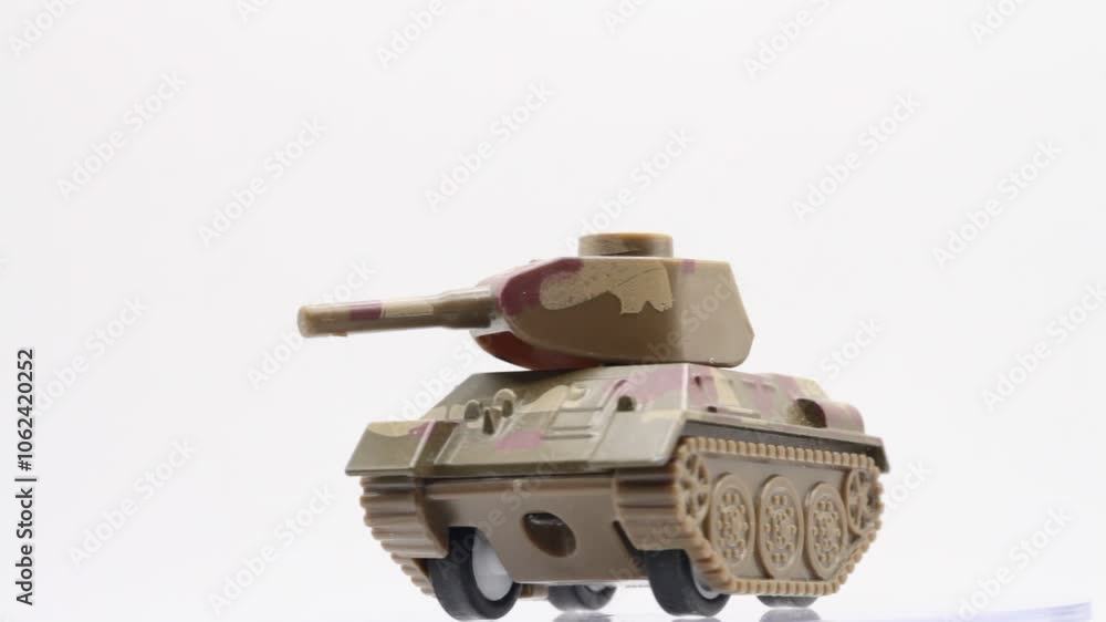 miniature of a toy tank rotating on a white background miniature of a toy tank rotating on a white background
