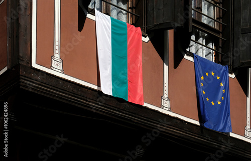 The national flag of Bulgaria and EU flag hanging from a window in Sofia