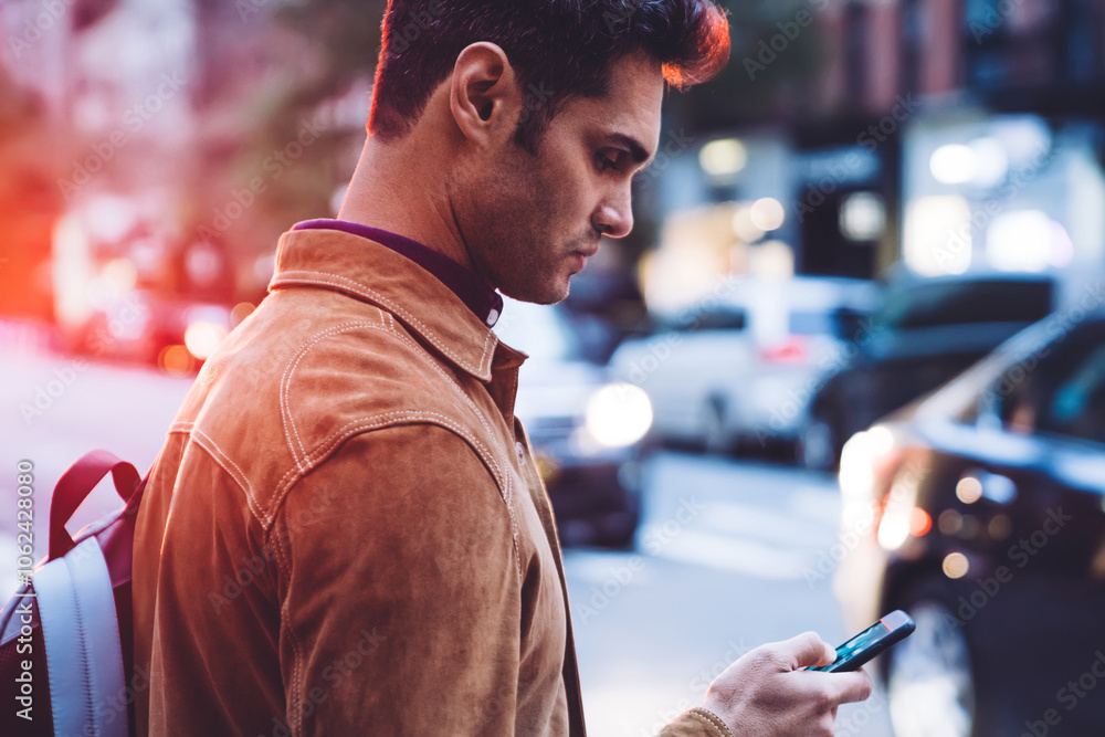 Focused young man browsing in smartphone at street Focused young man browsing in smartphone at street