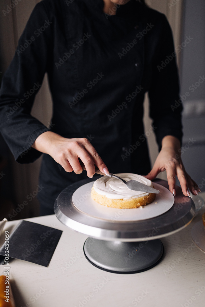 Close up of a woman decorating cake in the kitchen. Close up of a woman decorating cake in the kitchen.