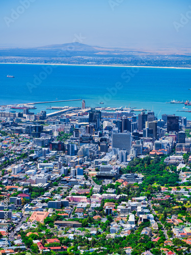 Afternoon vertical cityscape of Cape Town, featuring clear blue sky and Atlantic Ocean backdrop