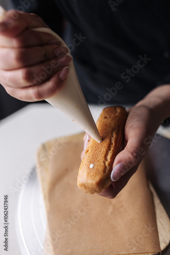 Pastry chef filled eclair with custard