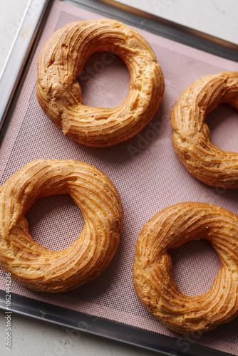 cream puff rings on a baking sheet