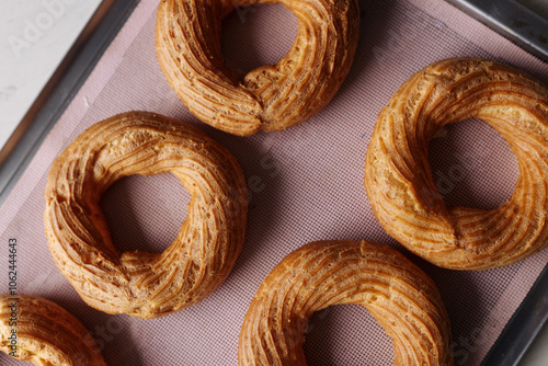 cream puff rings on a baking sheet