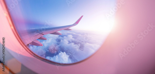 Fototapeta Naklejka Na Ścianę i Meble -  View from the cockpit of the plane to the beautiful clouds during sunset