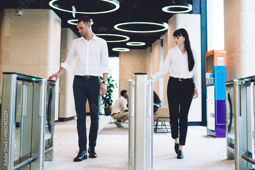 Focused coworkers going through checkpoint at workplace
