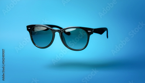 Sunglasses floating or flying isolated on light blue background