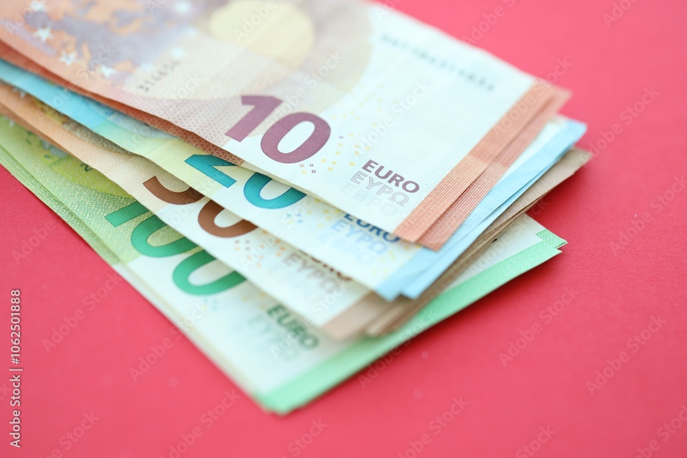 Big amount of one hundred, twenty, ten and fifty euro money bills on red background Big amount of one hundred, twenty, ten and fifty euro money bills on red background