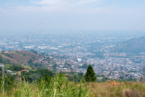 Cityscape of Cali from the Farallones Mountains, A sweeping view of Cali seen from the heights of the Farallones mountains, with the city’s dense, sprawling neighborhoods resembling a mosaic of closel photo