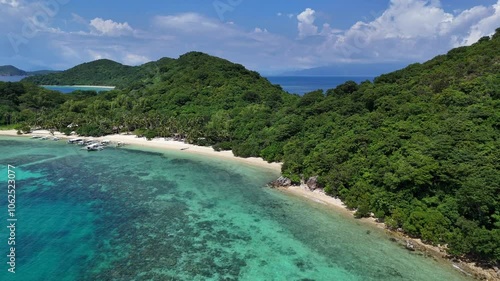 Aerial View of Tropical Island with Crystal Clear Water, White Sand, Lush Palms, and Boats on a Sunny Day – Stunning High-Resolution Drone Footage from the Philippines