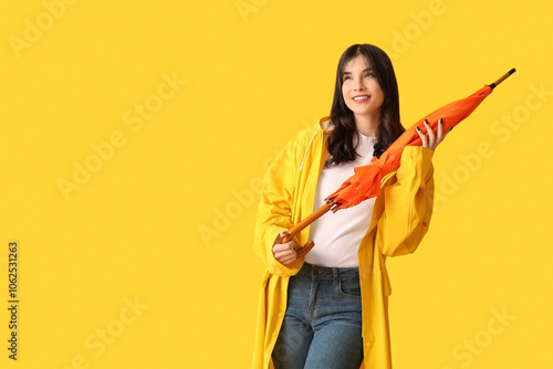 Young woman in raincoat wit...