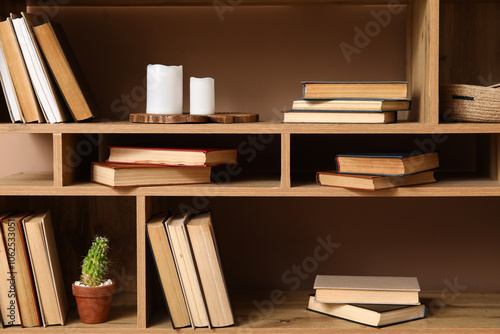 Wooden bookshelf with stack...