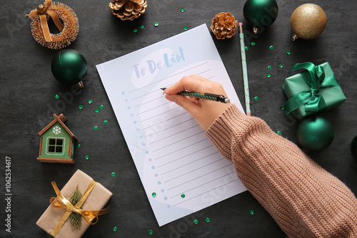 Woman writing to-do list wi...