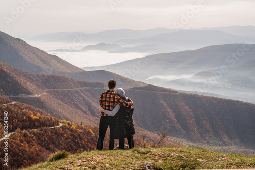 Photography A happy couple who hikers enjoys a break look at the top of the mountain adventure travel