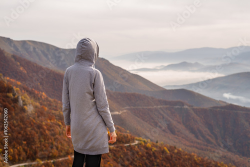 A woman traveler enjoys a break look at the top of the mountain.