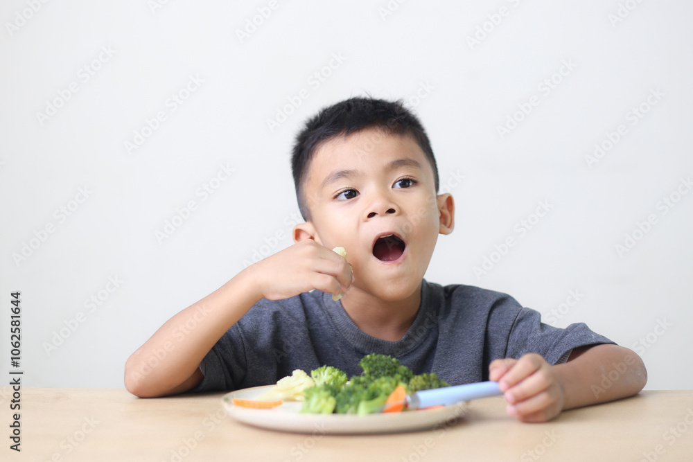 Nutrition healthy eating habits for kids concept. Children do not like to eat vegetables. Little cute boy refuses to eat healthy vegetables. Nutrition healthy eating habits for kids concept. Children do not like to eat vegetables. Little cute boy refuses to eat healthy vegetables.