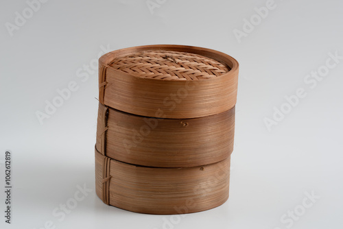 Traditional bamboo basket oriental dimsum steamer bas, isolated on white background photo