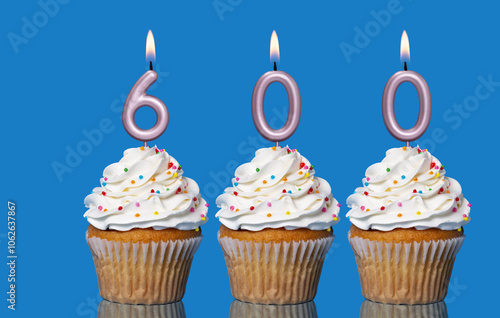 Birthday Cupcakes With Candles Lit Forming The Number 600 photo