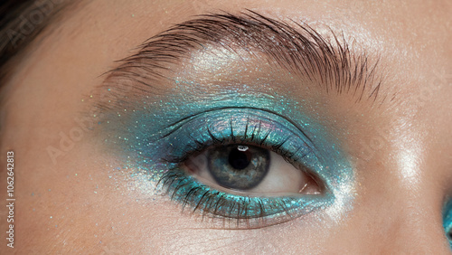 Mermaidcore Blue Eye-Makeup, Iridescent Pearl Finish: A close-up of an eye adorned with shimmering blue eyeshadow featuring an iridescent pearl finish photo