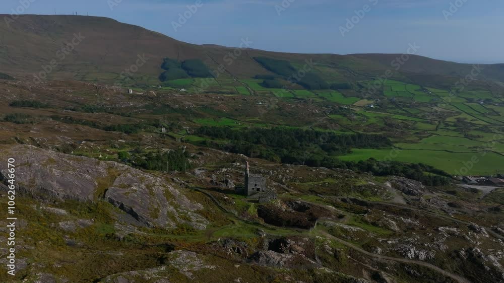 Copper Mine, Allihies, County Cork, Ireland, September 2024. Drone orbits clockwise around the ruined building on mountain slope surrounded by rugged fields under clear blue sky. Copper Mine, Allihies, County Cork, Ireland, September 2024. Drone orbits clockwise around the ruined building on mountain slope surrounded by rugged fields under clear blue sky.