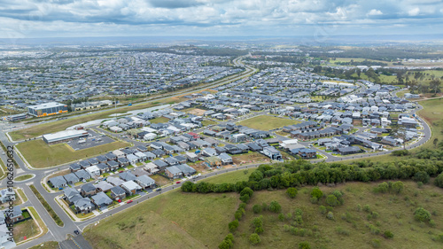 Drone aerial photograph of houses and infrastructure development in the fast growing suburb of Oran Park in the high density development region of western Sydney, NSW Australia.
