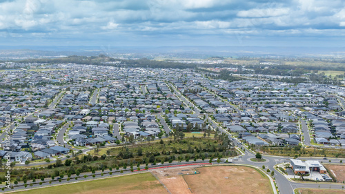 Photography Drone aerial photograph of houses and infrastructure development in the fast growing suburb of Oran Park in the high density development region of western Sydney, NSW Australia