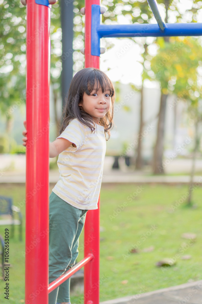 A child is playing outside in the playground. A child is playing outside in the playground.