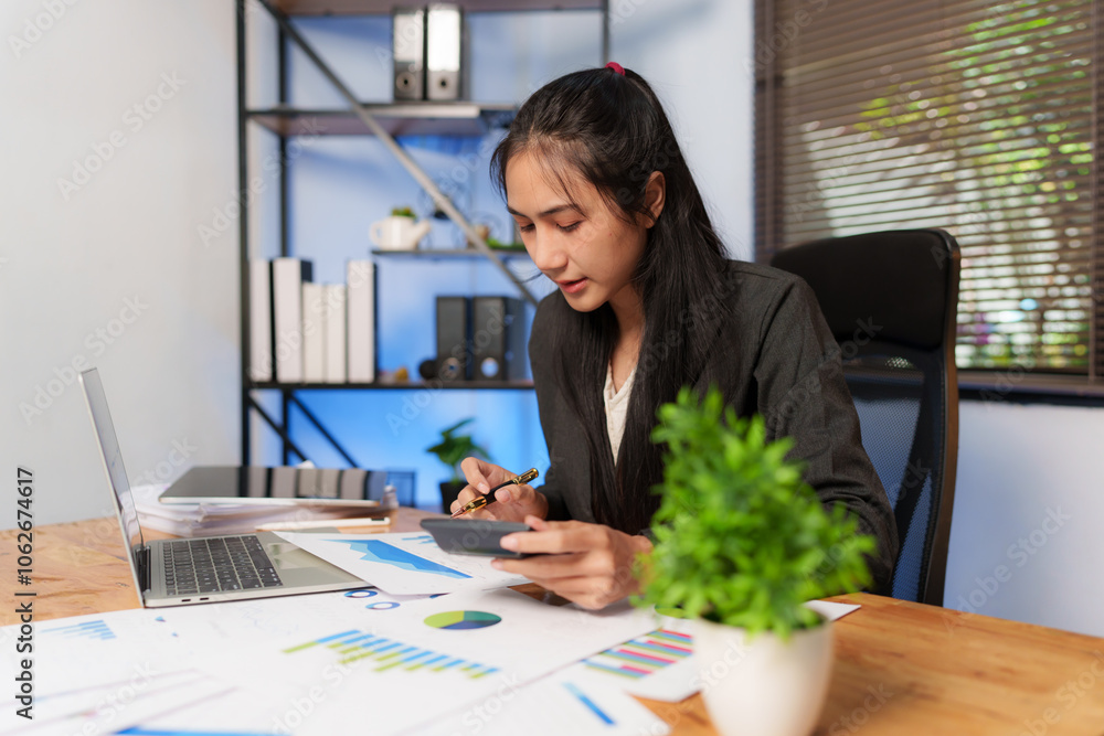Asian business woman happily working at office
Asian business woman happily working at office