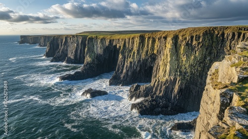 A rugged coastline with dramatic cliffs, waves crashing against the rocks below.