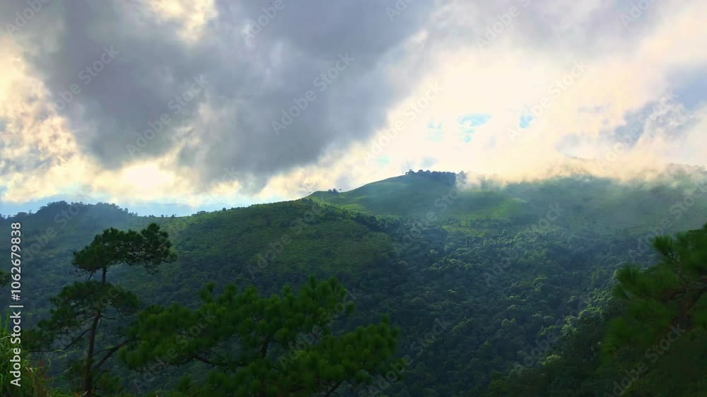 Timelapse video of serene view of mist covered mountains at sunset with soft light filtering through the clouds. Timelapse video of serene view of mist covered mountains at sunset with soft light filtering through the clouds.