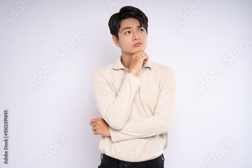 Portrait of young asian businessman wearing sweater and posing on white background