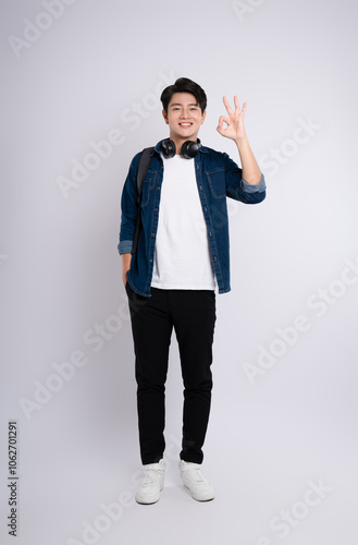 adult, advertisement, asian, background, backpack, casual, cheerful, chinese, confidence, cool, denim jacket, fashion, filipinos, formal, friendly, full, full body, gesture, happiness, happy, headphon photo