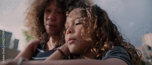 Latino little boy plays and learns with his mother for school with books and is happy