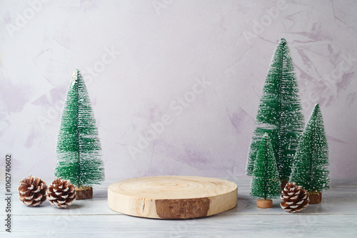 Empty log podium and pine tree decoration on white wooden table over bright wall  background. Christmas mock up for design and product display