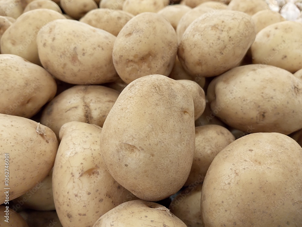 Raw potato food. Abstract shapes, patterns and textures of piles of potatoes. Potatoes look clean and fresh. For graphic design or banner background. Harvest potatoes. Raw potato food. Abstract shapes, patterns and textures of piles of potatoes. Potatoes look clean and fresh. For graphic design or banner background. Harvest potatoes.